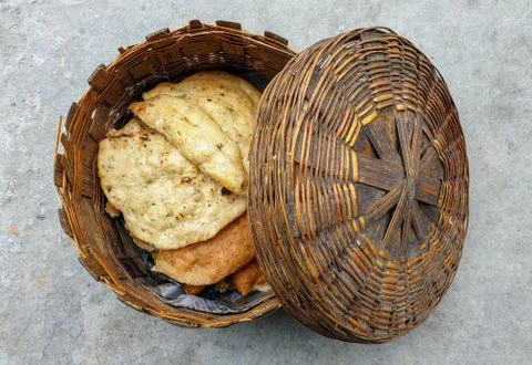 High angle view of bamboo basket with fried roti on it Stock Photos