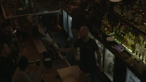 High-Angle View of Bartenders Working in Busy Pub Stock-Footage 343951727