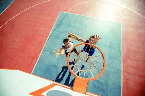 High angle view of basketball player dunking basketball in hoop Stock Photos