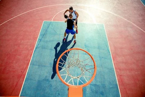 High angle view of basketball player dunking basketball in hoop Stock Photos