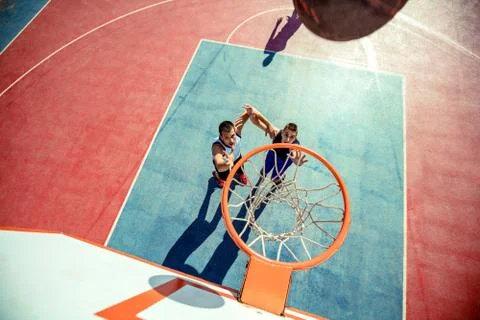 High angle view of basketball player dunking basketball in hoop Stock Photos