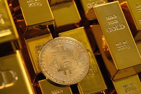 High angle view of a bitcoin coin among many gold bars Stock Photos