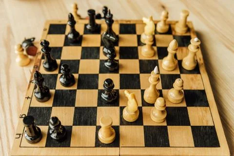 High angle view of black and white chess pieces on chessboard during the game Stock Photos