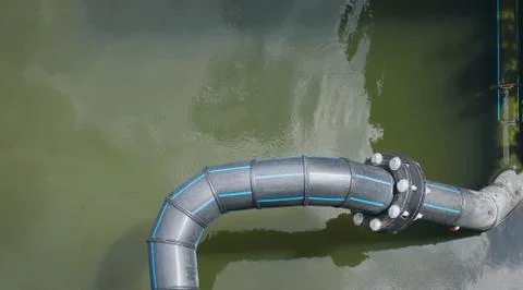 High Angle View of Black Flexible HDPE Pipes and Bolted Connection Flange Stock Photos