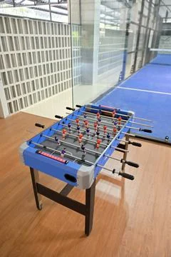 High-angle view of a blue foosball table positioned on a wooden floor, vert.. Stock Photos
