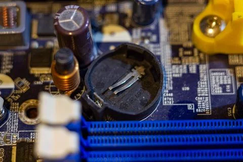 High angle view of blue printed circuit board showing capacitor and memory slots Stock Photos