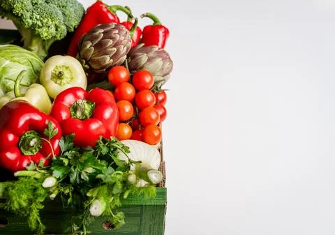 High angle view of box with farm grown organic vegetables on white background Stock Photos