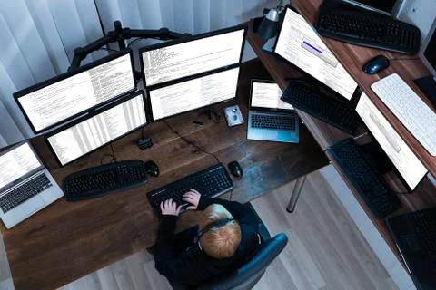 High Angle View Of A Boy Working On Multiple Computers 스톡 사진
