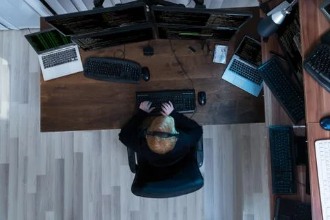 High Angle View Of A Boy Working On Multiple Computers Foto stock