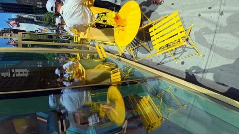 A high angle view of bright yellow tables and chairs as a storefront attraction Stock Footage 341846764