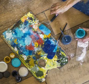 High angle view of brushes, pallete, oils, acrylics and other elements of a.. Stock Photos