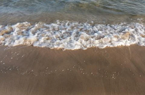 High Angle View of Bubbling Sea Foam and Waves on Sandy Beach at Inland Sea. Stock Photos