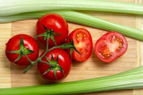 High angle view of bunch of fresh tomatoes and celery sticks 스톡 사진