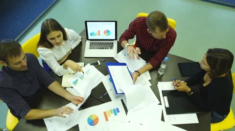 High-angle view of businesspeople having a meeting at office, sitting around the Stock Footage 67971084
