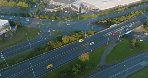 High-angle view of busy highway intersections, parking lots, and buildings. MT Stock-Footage 296037107
