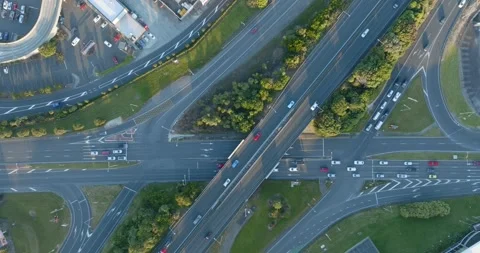 High-angle view of busy highway intersections, parking lots, and buildings. MT Video stock 296037172