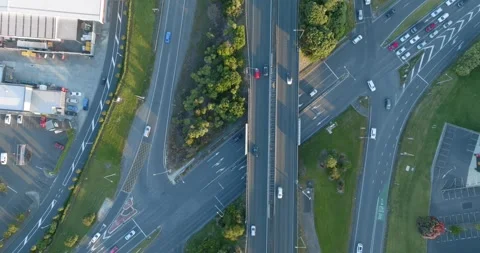High-angle view of busy highway intersections, parking lots, and buildings. MT Stock-Footage 296037185