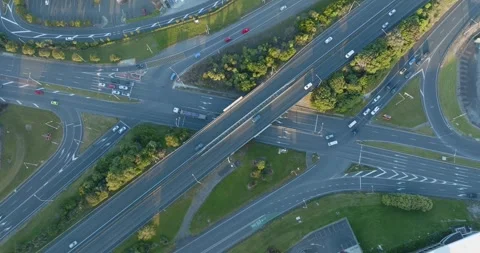 High-angle view of busy highway intersections, parking lots, and buildings. MT Stock-Footage 296037188