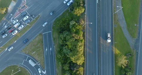 High-angle view of busy highway intersections, parking lots, and buildings. MT Stock-Footage 296037451