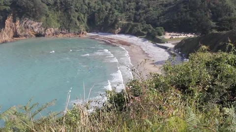 High angle view of Cadavedo beach cove surrounded by green cliffs in Asturia Stock Footage 343897464