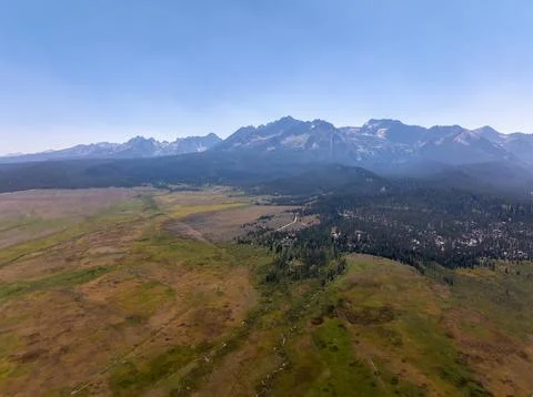 High-angle view captures expansive grasslands and forested areas Stock Photos