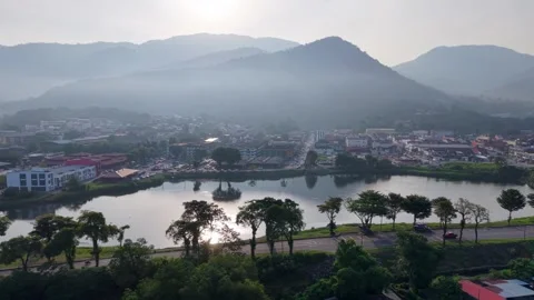 High angle view captures sunrise mountains, town nestled below Видео 346918908