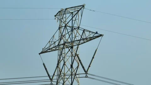 A high-angle view captures a tall transmission tower. Stock Footage 306142845