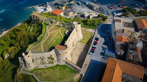 High-angle view of Castello Aragonese overlooking turquoise waters along th.. Stock Photos