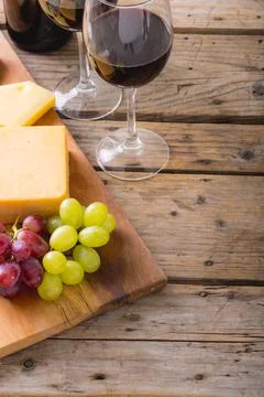 High angle view of cheese with grapes and red wine on table, copy space Stock Photos