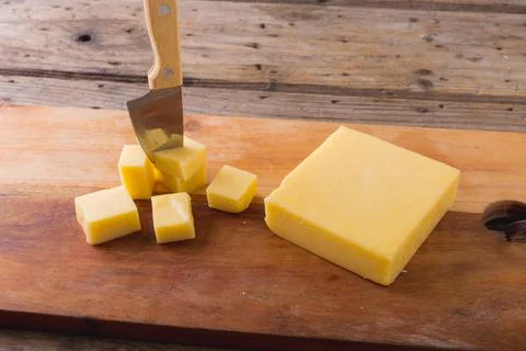 High angle view of cheese with knife on board at table, copy space Stock Photos