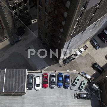 High angle view of city buildings and parked cars Stock Photos