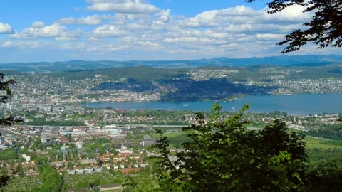High angle view of a city coastline and large lake under a blue sky with white Stock Footage 334866241