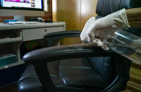 High angle view, cleaning a black work chair (wrong and dangerous method) 스톡 사진