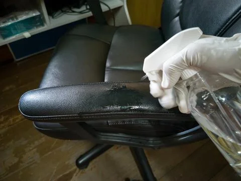 High angle view, cleaning a black work chair (wrong and dangerous method) Stock Photos