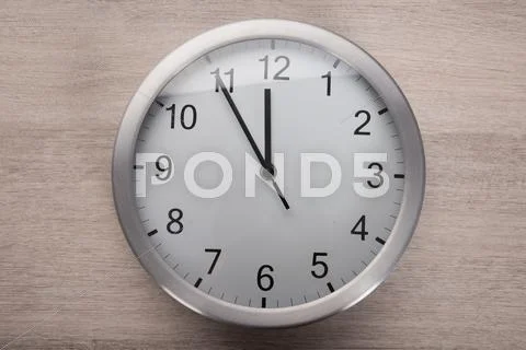 High angle view on clock showing five before noon Stock Photos