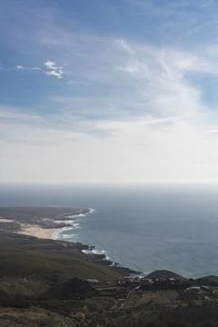 High angle view of coastline, with beach, ocean, blue sky and horizon Stock Photos