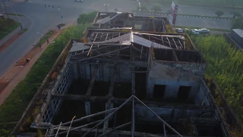 High angle view of a collapsed rooftop of a large structure in a suburban Stock Footage 320111571