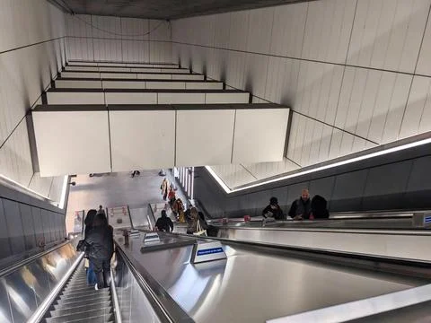 High angle view of commuters on a modern escalator at an Elizabeth Line station Stock Photos