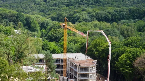	High-angle view of a concrete pump truck and yellow tower crane Video stock 342763837