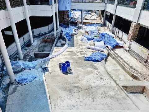 High Angle View at Construction Site with Groups of Blue Bins and Striped Can Stock Photos