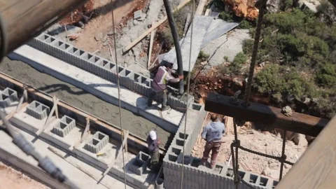 High angle view of construction workers pouring concrete in construction site Stock Footage