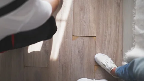 High-angle view of a contractor using a measuring tape on a new wooden floo.. Stock Footage 344807792