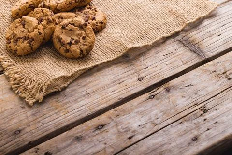 High angle view of cookies on burlap at wooden table, copy space Stock Photos