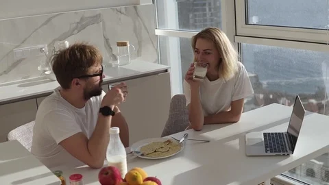 High angle view of couple smiling with joy at good morning in modern kitchen 動画素材 123468090