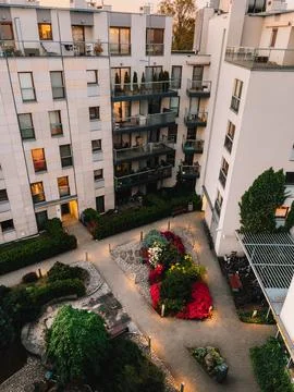 High angle view of courtyard with playground, garden, and illuminated paved Stock Photos
