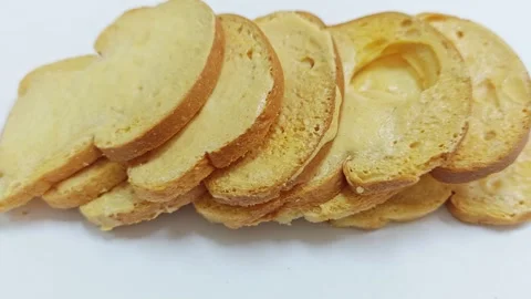 High angle view of crispy baked bread rusks on white background. 스톡 동영상 339991086