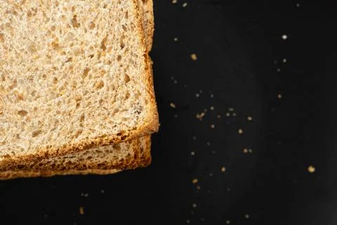 High angle view of crispy grain toast slices served for breakfast on dark b.. Fotos Stock