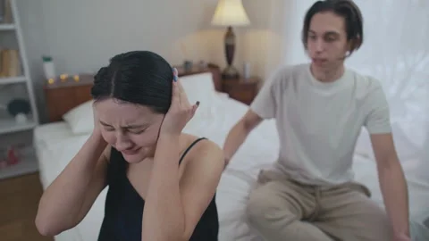 High angle view crying young woman covering ears with hands as angry furious man Video stock 240725344