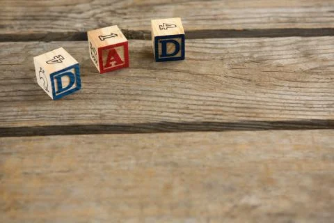 High angle view of cube shapes with dad text and numbers on table Foto stock