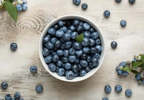 High angle view of a cup of blueberries on the old wooden desk Stock Photos